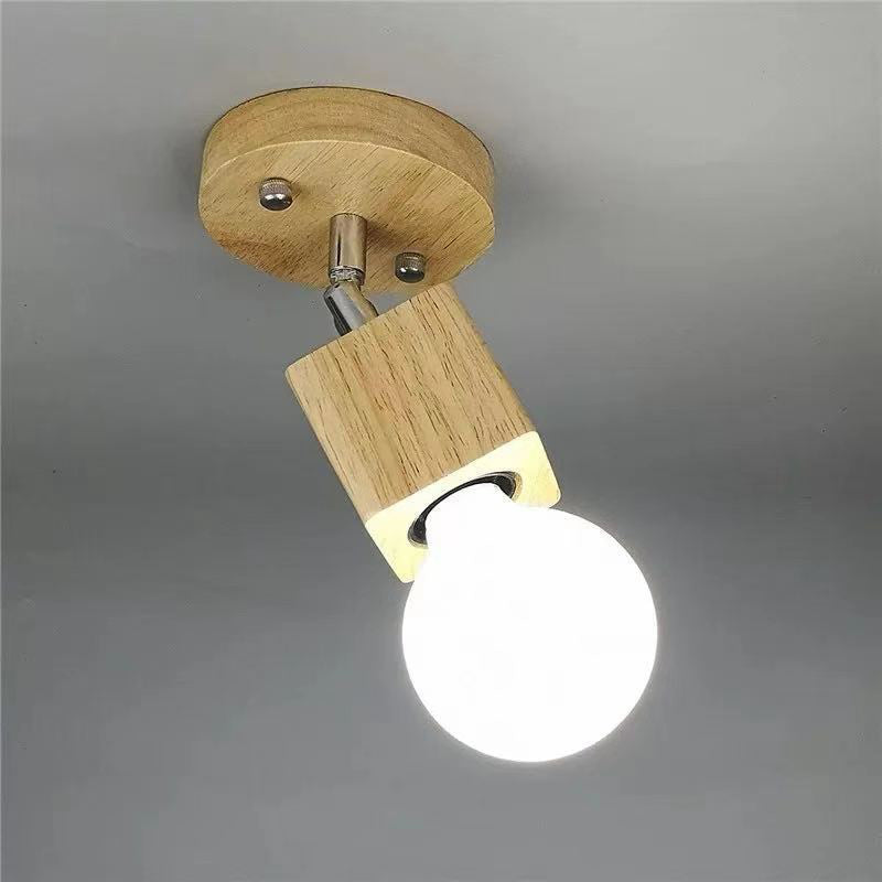 Detailopname van de houten kap, arm, bolvormige lampenkap en lamp van de halfverzonken plafondlamp.