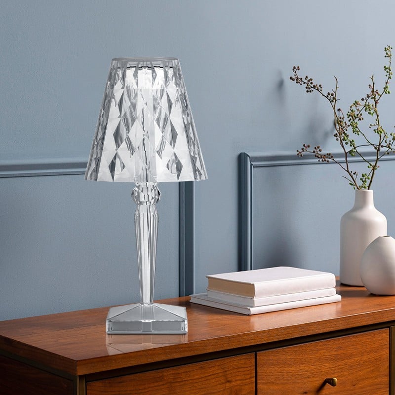 Lampada esposta su un mobile con libri e vaso