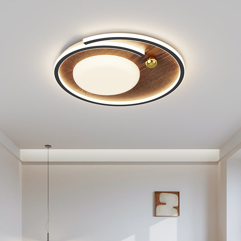 Plafoniera rotonda a LED color noce installata in una camera da letto
