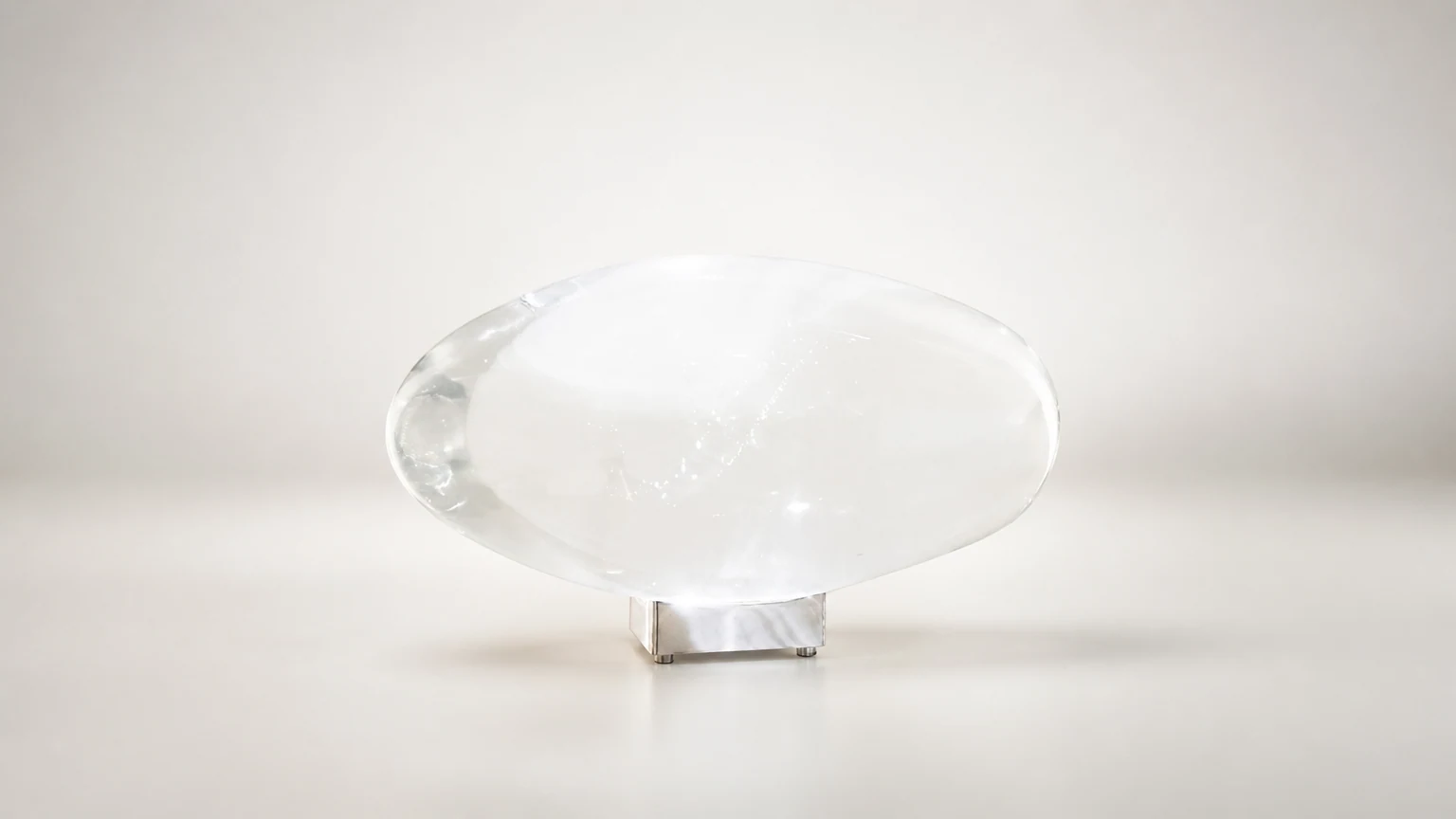 Creatieve tafellamp van kristal in kiezelvorm in een warm interieur.